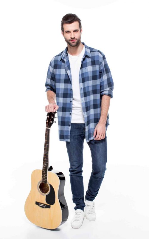 oven músico de pie sosteniendo su instrumento en el escenario durante un certamen de música, con una expresión de confianza y preparación
